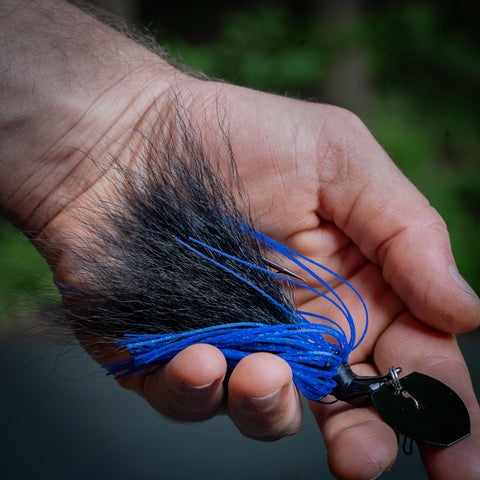 A hand holding a black & blue Hybrid Vibe